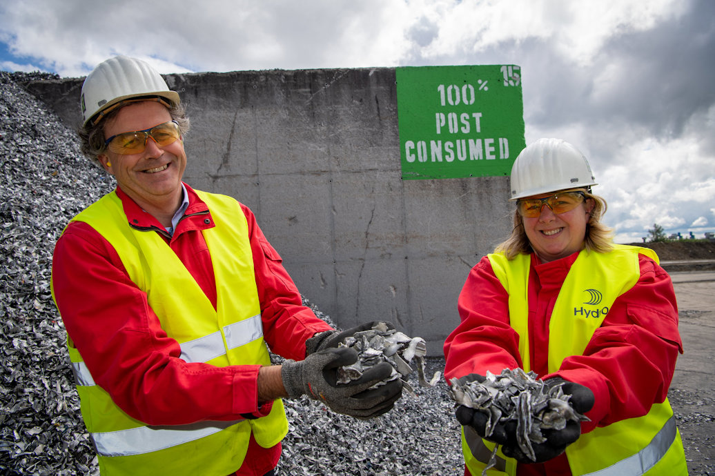 a man and woman wearing hard hats and holding a rock