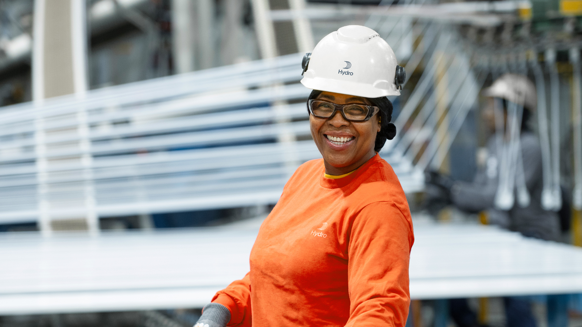 a woman wearing a hard hat and glasses
