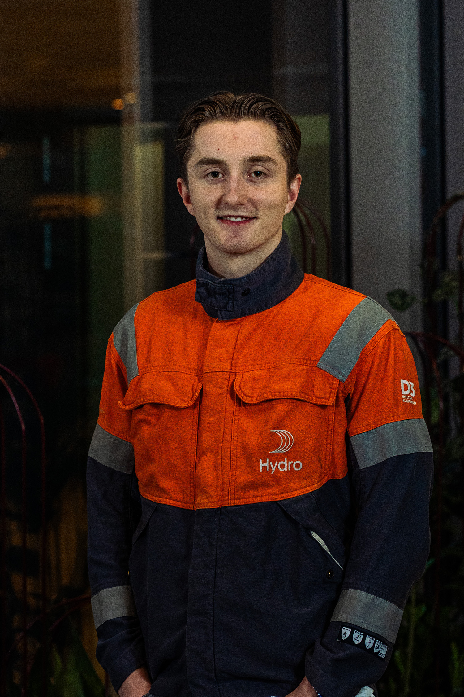 a man in an orange and black overalls