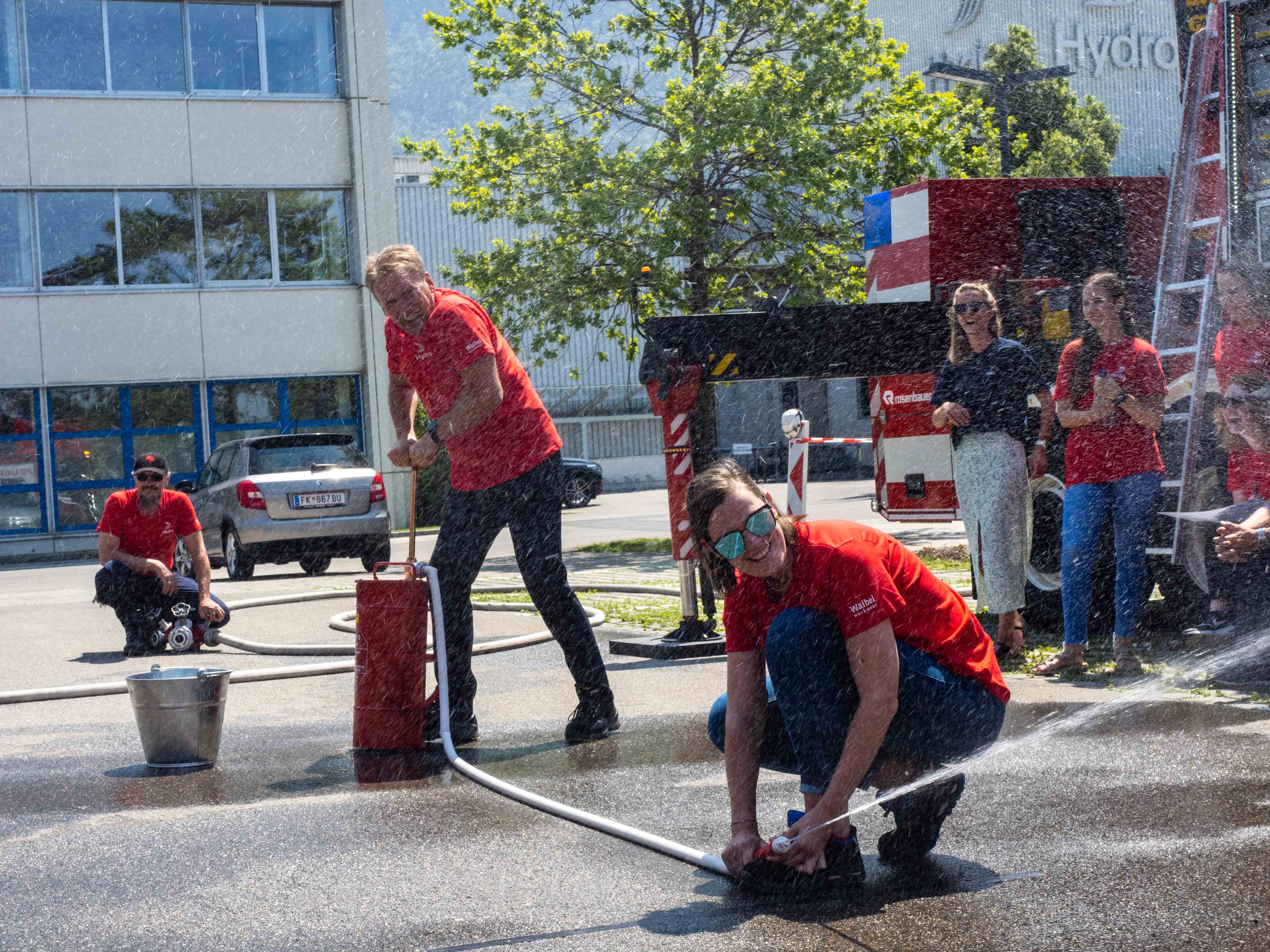 a group of people working on a fire hydrant
