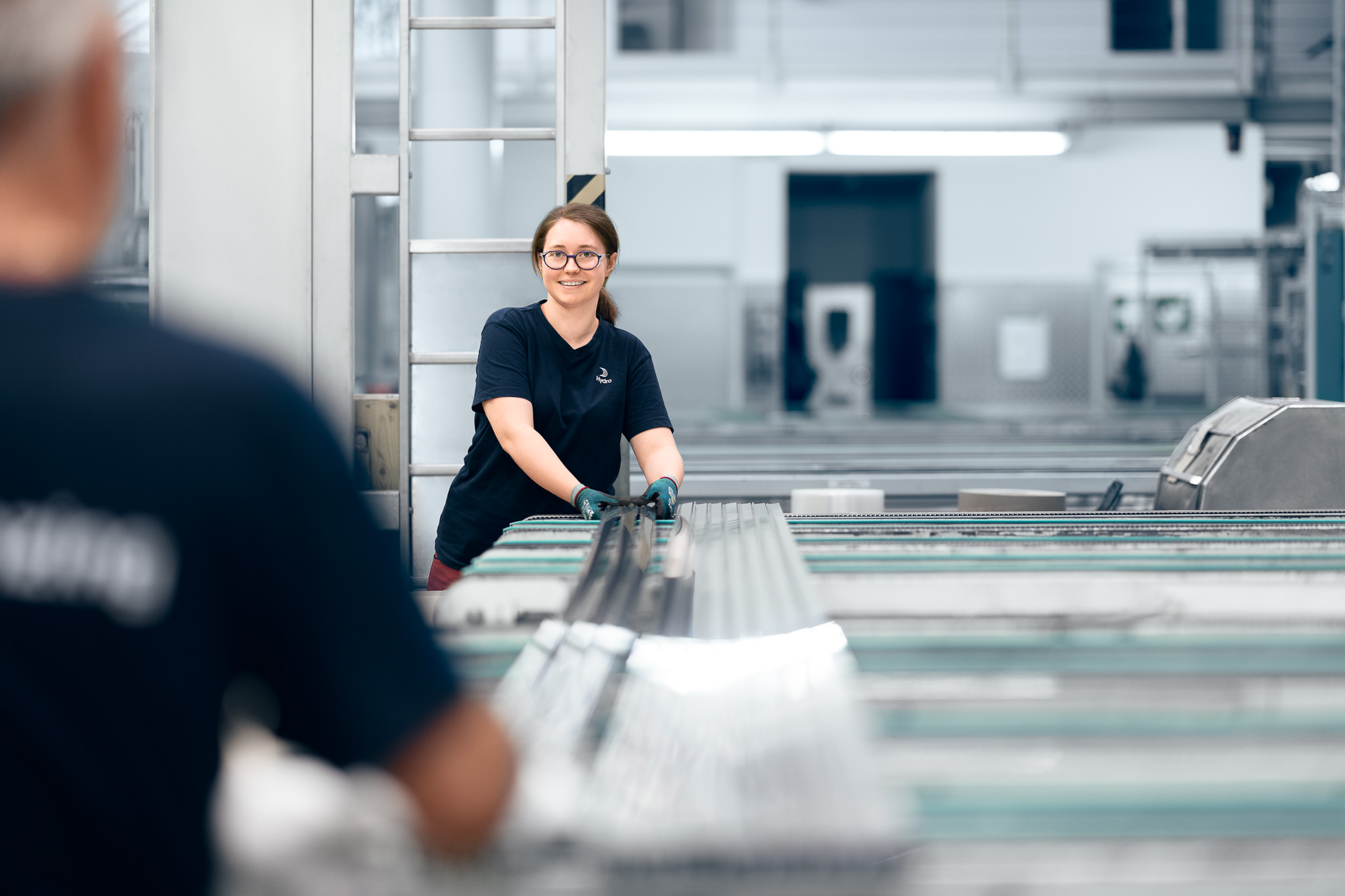 a woman and a man working in the packaging area