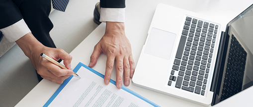 A hand signing a contract