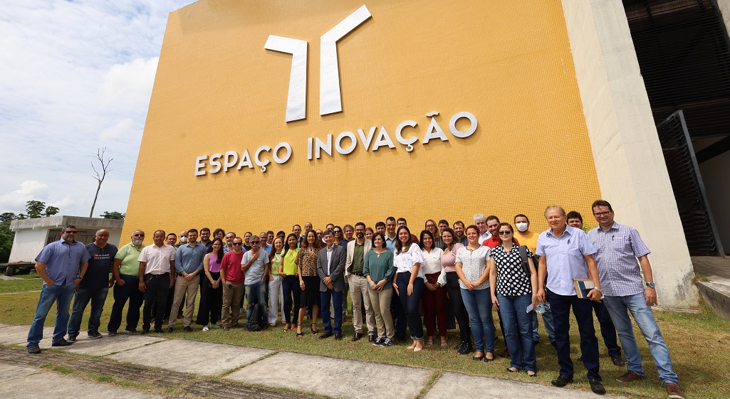 a group of people posing for a photo in front of a building
