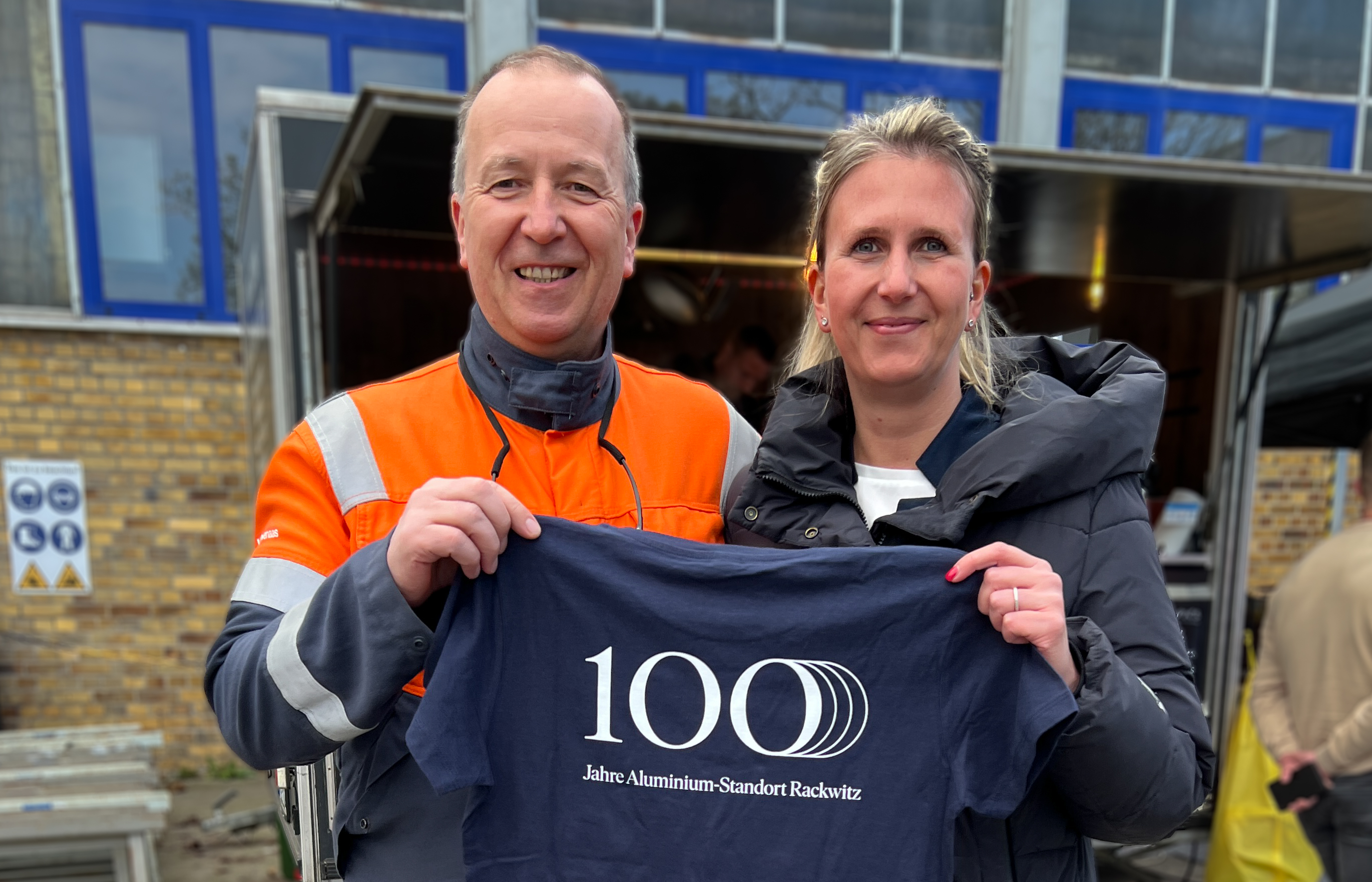 a man and woman holding a t-shirt