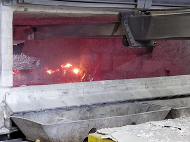 a large metal container with a red liquid inside